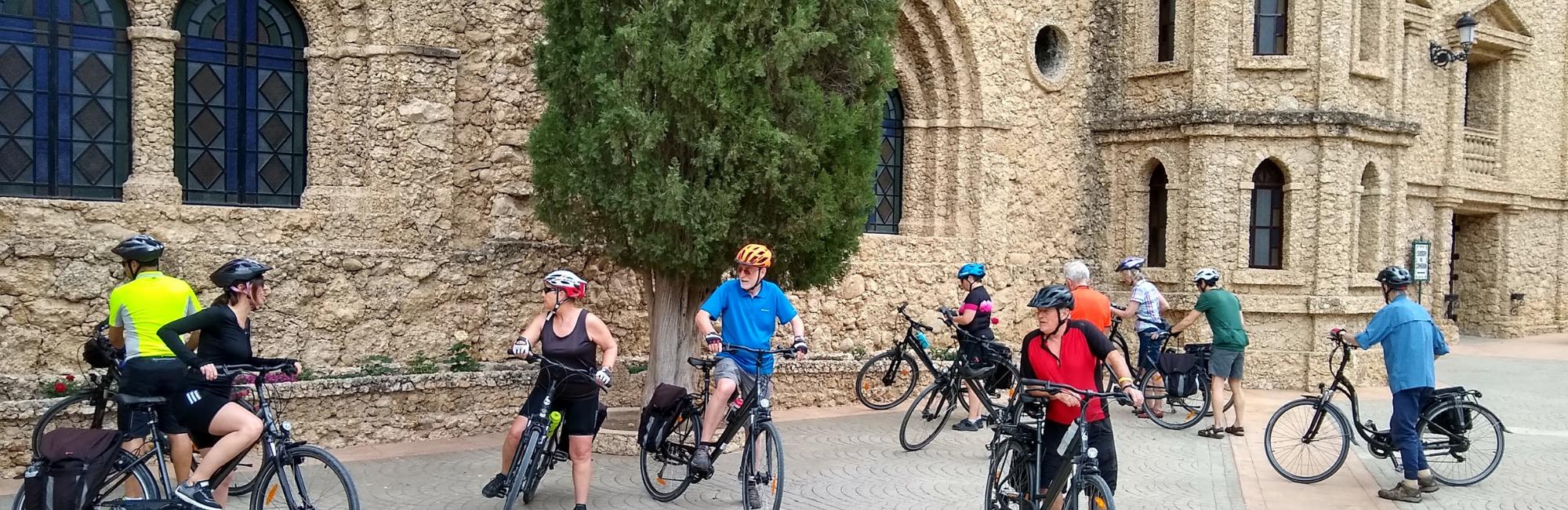 Group of cyclist in front of a church in Murcia