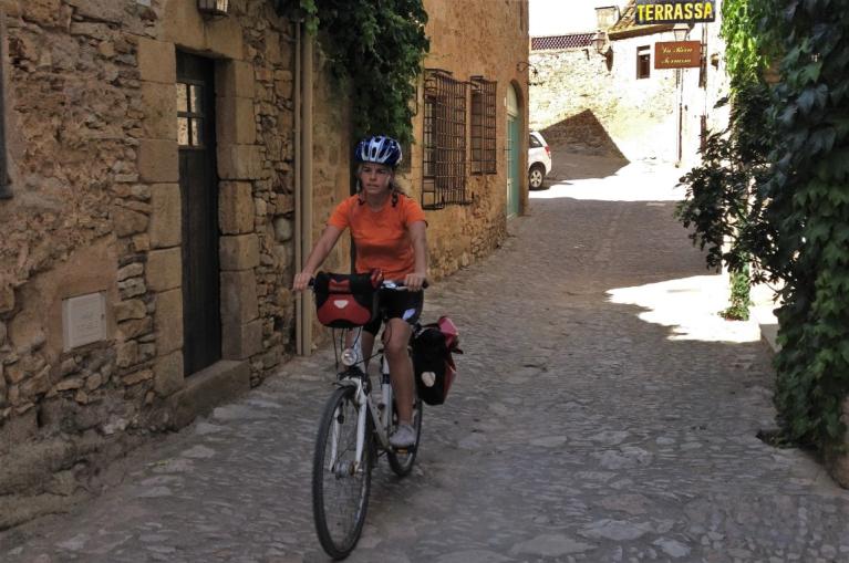 Cyclist in a tipical Baix Empordà village